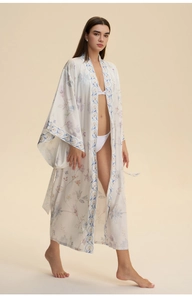 Detail of floral printed white kimono cover up with elegant blue and lavender vine patterns