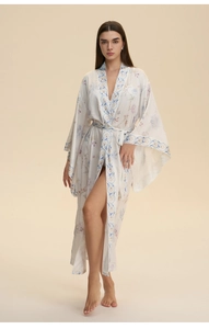 Detailed view of white satin robe with blue floral prints and silky smooth texture