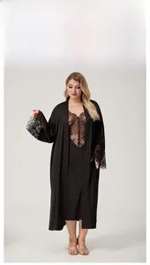 Detail of long-sleeved black satin robe with intricate lace trim on cuffs and V-neckline