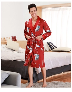 Detail of red silk bathrobe for men featuring traditional white crane print and belt