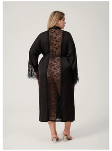 Detail of black satin bathrobe featuring delicate lace patchwork on back and sleeve cuffs