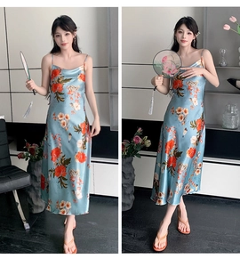 Detail of blue satin slip dress with red floral print in a modern interior setting