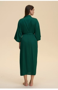 Detail view of the emerald green satin long robe's smooth fabric and wide sleeves
