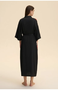 Back view of a long black satin kimono robe with elegant red and white floral prints
