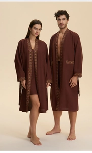 Detail of dark brown couple bathrobes with bohemian print trim on sleeves and pockets