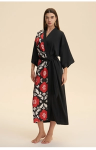 Detail of long satin kimono robe featuring a half floral print and half solid black design