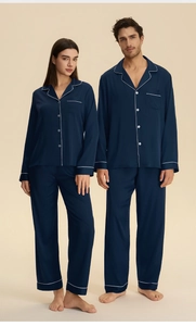 Classic navy blue satin couple pajamas with white piping details and button-down collar
