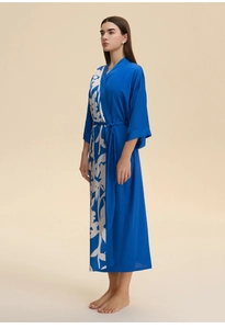 Detail of soft satin kimono robe featuring a blue floral print and elegant belted waist
