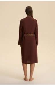 Detail view of burgundy luxury bathrobe with ethnic floral embroidery on cuffs and belt