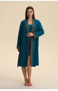 Detail of teal silk-like pajama set with geometric pattern piping on cuffs and collar