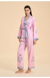 Detail of pink satin loungewear with grey leaf patterns and soft silky texture
