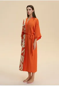 Detail of orange satin kimono robe showing leaf print pattern and waist tie belt