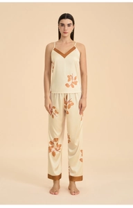 Detailed view of women's satin pajama set featuring maple leaf print and silky texture