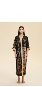 Detail of floral satin bridal robe featuring paisley print and tan contrast trim