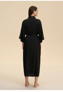Detail of black satin long robe featuring a smooth silk texture and adjustable waist belt