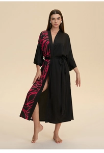 Detail of soft black satin kimono robe with pink floral pattern and waist tie belt
