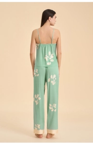 Rear view of loose satin pajama set with leaf print, spaghetti strap top and wide leg pants