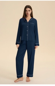 Detail of navy satin pajama set with contrast piping and button-down lapel collar