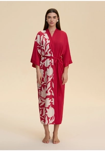 Detail of red satin kimono robe with large white floral pattern and waist tie