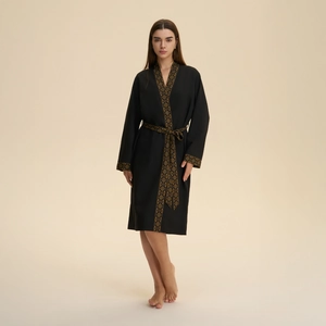 Elegant black kimono robe with gold geometric trim and waist tie for a luxury loungewear look