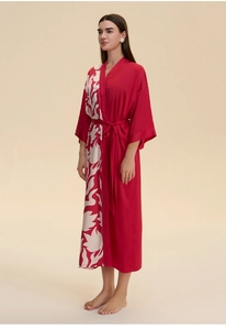 Detail of red satin kimono robe with white floral print and elegant matching waist tie