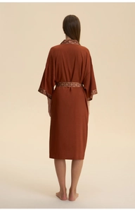 Back view of a brick red satin robe for women featuring vintage patterned trim detailing