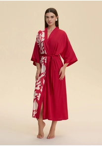 Detailed view of red satin kimono robe with white floral print and matching belt