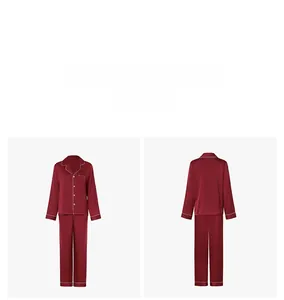 Detail view of burgundy satin pajama set featuring white piping on collar and long pants