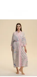 Floral print long robe with bird patterns and pink trim on a mauve kimono style