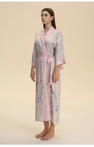 Detail of floral and kingfisher print on long-sleeved satin bathrobe with waist tie