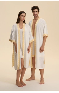 Detail view of cotton linen sleepwear with yellow floral patterns on the trim