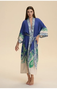 Detail of long-sleeved silk bathrobe with paisley print and matching waist tie