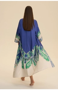 Rear view of long satin nightdress with blue and white paisley print and green floral trim