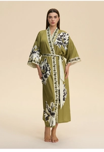 Macro detail of the silky olive green floral kimono robe with decorative printed trims