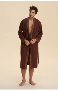Detail of dark brown bathrobe with ethnic geometric patterns on the sleeve and pocket