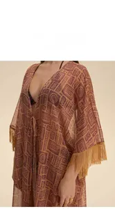 Detail showing the sheer chiffon fabric texture and tassel fringe on the ethnic printed robe