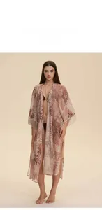 Detailed view of bohemian floral chiffon robe featuring fringed sleeves and side slits