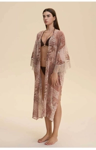 Detail of bohemian floral chiffon kimono with elegant tassel trim on the sleeves