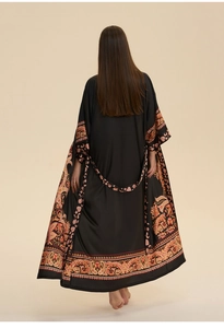 Back view of long black kaftan nightdress featuring ethnic paisley prints and waist tie