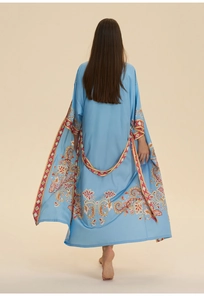 Detail of light blue floral paisley pattern on silk-like long kimono robe nightdress