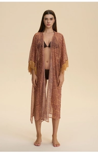 Detail of bohemian print beach cover-up with stylish tassel fringe on the sleeves