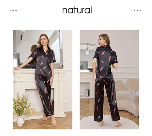 Detail of black silk pajamas with pink feather print and elegant piping finishes