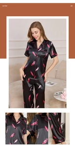 Detail view of pink feather print on black silk pajamas with red piping and buttons