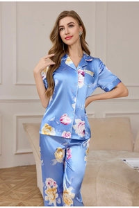 Detail of blue silk pajama set with pink floral prints and satin texture finish
