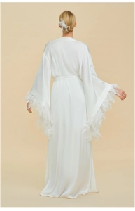 Detailed back view of white silk robe with luxury feather trim on kimono sleeves