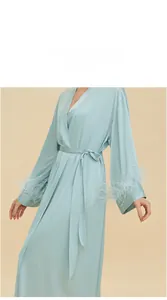 Detailed view of light blue satin robe featuring luxurious feather trim on the cuffs