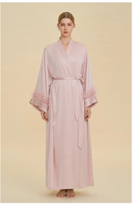 Detail of light pink satin robe featuring luxury ostrich feather trim on the wide sleeves