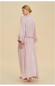 Detailed back view of long pink satin robe with luxurious feather cuffs and waist tie