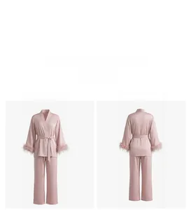 Detailed view of pink satin pajama set featuring luxurious detachable feather cuffs