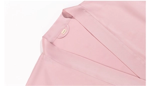 Close-up of pink satin robe collar showing fine stitching and One Size label tag